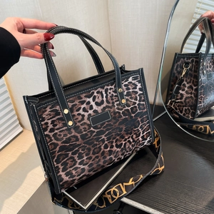 Retro leopard print tote bag with black handles and a stylish wide patterned shoulder strap