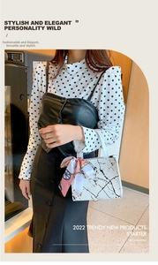 Close-up of a white marble texture handbag with pink floral scarf on the handle