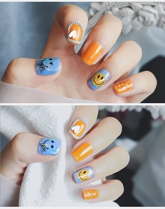 Nahaufnahme von 5D-Nagelaufklebern mit orangen Smileys, Sternen und Herzmustern