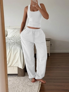 Mirror selfie showing white racerback tank top and matching drawstring jogger set