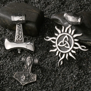 Detailed macro view of three Viking Thor's Hammer pendants with intricate embossed patterns