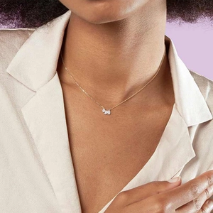 Close-up of golden S925 silver necklace featuring a cute dog pendant with pavé crystals