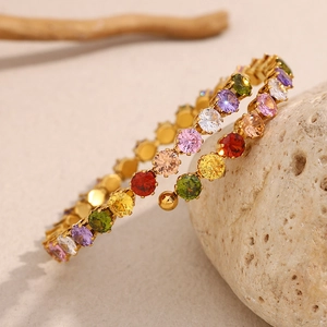 Detail of 18K gold plated stainless steel bracelet with colorful round zirconia stones