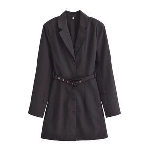 Detail of black blazer dress lapel with single-breasted button and waist belt detail