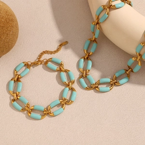 Detail of 18K gold plated chain necklace and bracelet set with green enamel links