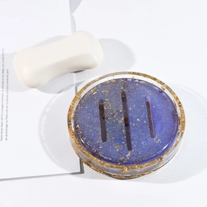 Detail of purple resin oval soap dish with gold foil flakes and drainage slots