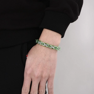 Close-up of 8mm stainless steel cuban link chain bracelet in green and silver finish