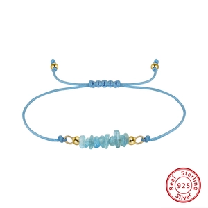 Detail of light blue natural stone bracelet with 925 silver gold-plated beads