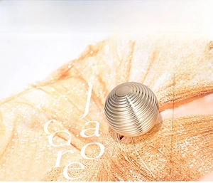 Macro detail of the golden luxury cosmetic jar lid with high-gloss concentric circular textures