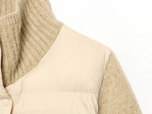 Detailed macro of the oatmeal knitted rib collar and quilted patchwork jacket texture