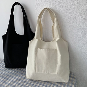 Detail of minimalist canvas tote bags in black and beige with external pockets