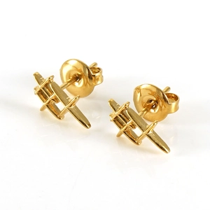 Detail of minimalist gold geometric cross earrings with polished mirror finish surface