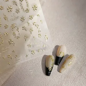 Detail of M-891 gold embossed nail stickers with floral patterns on nail tips