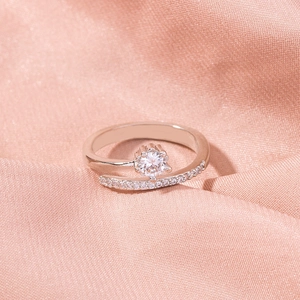 Detail view of silver ring with bypass band and sparkling cubic zirconia pavé setting