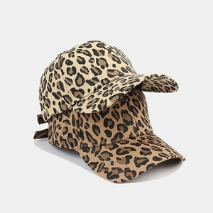 Detail view of double stacked leopard print baseball caps with adjustable straps