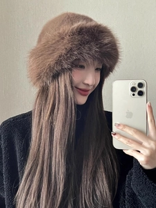 Close-up of brown faux fur bucket hat with matching long hair extension accessory