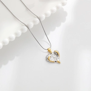 Minimalist two-tone heart pendant necklace with gold and silver hammered texture finish