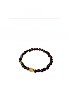 Detail of beaded bracelet with red sandalwood, blue crystal, and amber beeswax beads