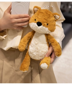 Close-up of soft plush fox doll with long limbs and fluffy texture held by a model