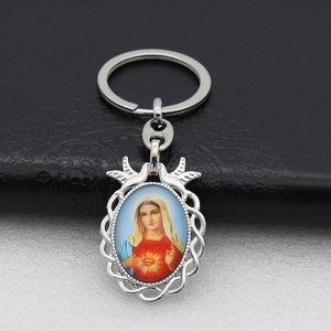 Detail of silver religious keychain with Virgin Mary portrait and woven metal frame