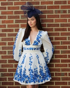 Detail of floral long sleeve swimsuit with deep V-neck and puff sleeves on a model