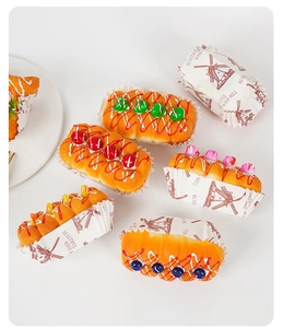 Macro view of assorted PU squishy jam bread toys with decorative wind mill paper cups