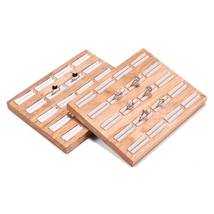 Wooden jewelry ring display tray with beige velvet lining and multiple slots