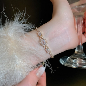 Close-up of luxury gold-plated adjustable bracelet featuring rectangular cubic zirconia stones