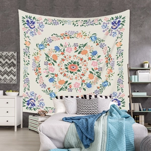 Detailed close-up of a floral mandala tapestry with vibrant orange and blue patterns