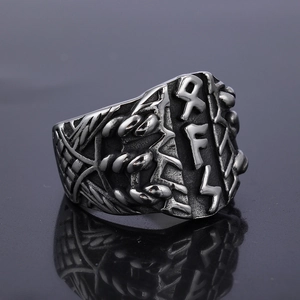 Macro shot of vintage Viking stainless steel ring with embossed Runes and woven texture