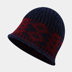 Close-up of winter knit bucket hat with navy and red geometric jacquard rib texture