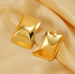 Detailed macro view of 18K gold plated rectangular earrings with high polished concave finish