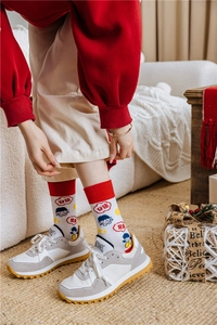Detail of red festive cotton socks with cartoon pattern and lucky Chinese characters