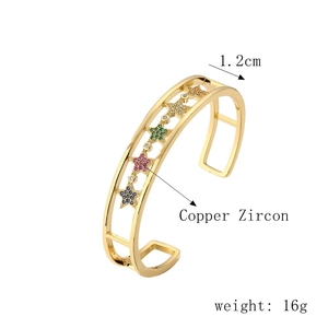 Macro view of 1.2cm wide gold star cuff featuring colorful zircon stones and brass