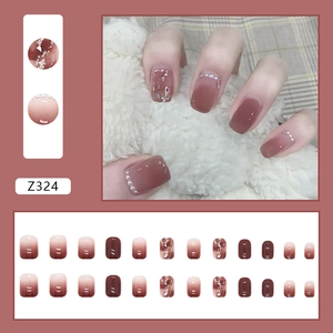 Detail of 24pcs pink gradient press-on nails with pearls and silver foil decorations
