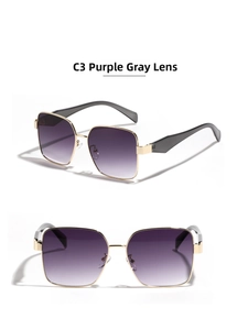 Detail view of large metal square sunglasses with gold frames and gradient purple lenses