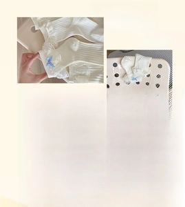 Close-up of white lolita socks with delicate lace trim and blue checkered bows