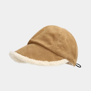 Detailed side view of warm corduroy bucket hat with white faux lamb wool trim and drawcord