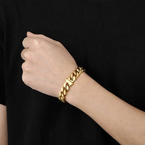 Close-up of a 12mm 18K gold plated Cuban link chain necklace on a male model