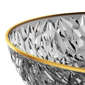 Macro detail of diamond-cut crystal fruit bowl with elegant gold gilded rim