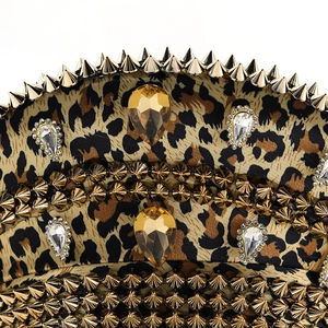 Detail of leopard print hat with golden cone studs and amber gemstone embellishments