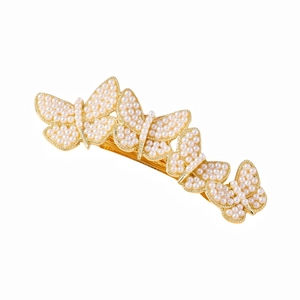 Elegant gold butterfly hair clip with white pearls and rhinestones on a white background