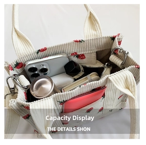 Interior capacity view of strawberry embroidered corduroy tote bag showing storage space