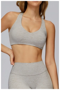 Close-up of heather gray brushed yoga bra with high-elastic knit texture and deep V-neck