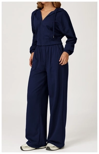 Detail view of dark blue knit hooded tracksuit set with wide leg pants on model