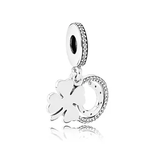 Silver four-leaf clover charm with shimmering stones and tree of life details