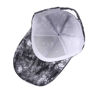 Detail view of the 100% cotton inner lining and wash label of tie-dye baseball cap
