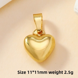 Macro shot of 11x11mm 3D gold heart pendant with polished mirror finish and bail