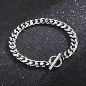 Sleek stainless steel Cuban link bracelet with OT toggle clasp on dark starry background