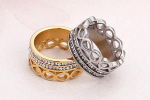 Detailed macro view of infinity symbol gold and silver rings with double-row crystals